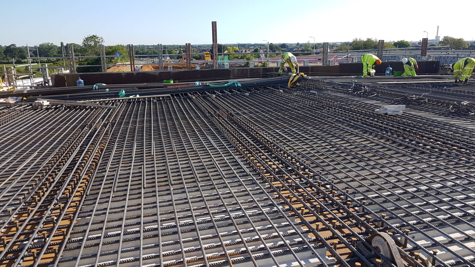 Quick-Steel-Fix crew working a wide bridge deck reinforcement mat