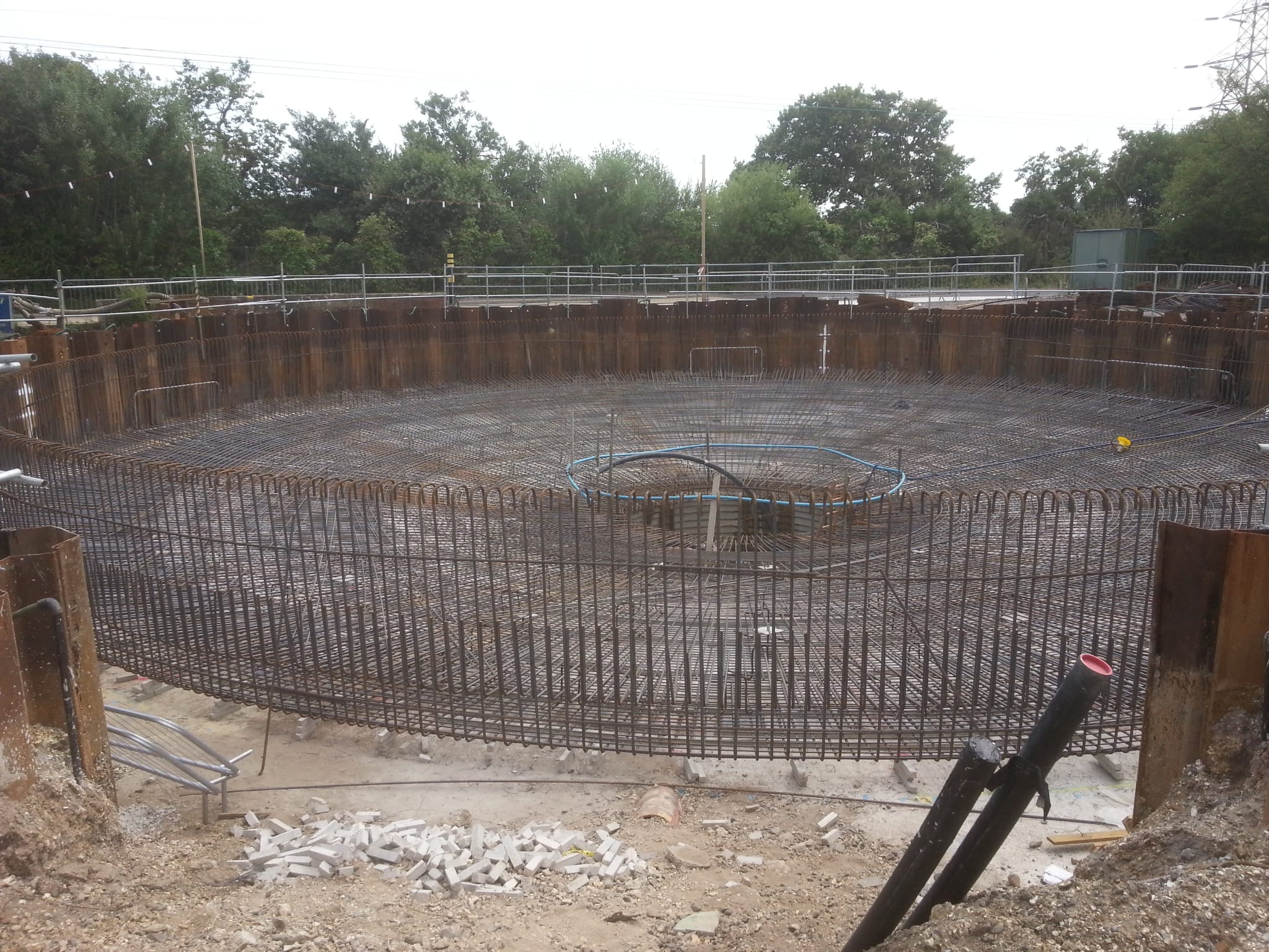 Large circular tank reinforcement inside steel sheet piling, ready for the concrete pour
